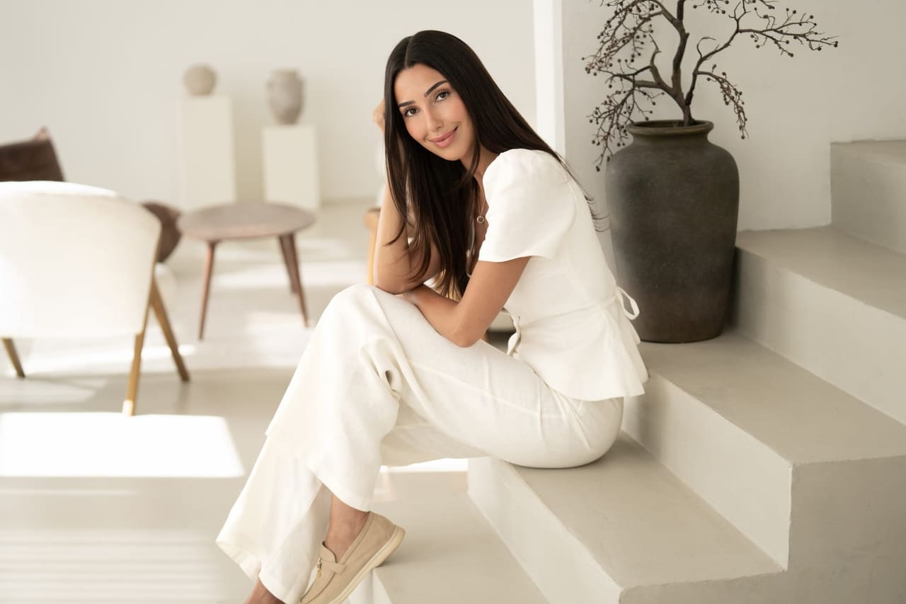 Aylin Yonca Örün seated on a light-coloured staircase